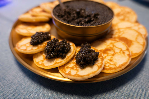 Fresh Imperial Amur Caviar showcased on elegant black dish