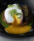 Fresh Kaluga Amur Caviar displayed on a sophisticated black dish