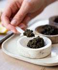 Fresh Crystal Beluga Caviar elegantly presented on a black plate