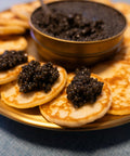 Fresh Imperial Amur Caviar showcased on elegant black dish